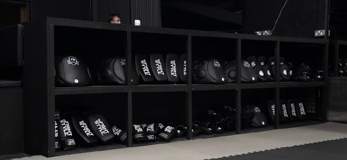 Shelving stacked with pads, gloves and shin guards for members to use