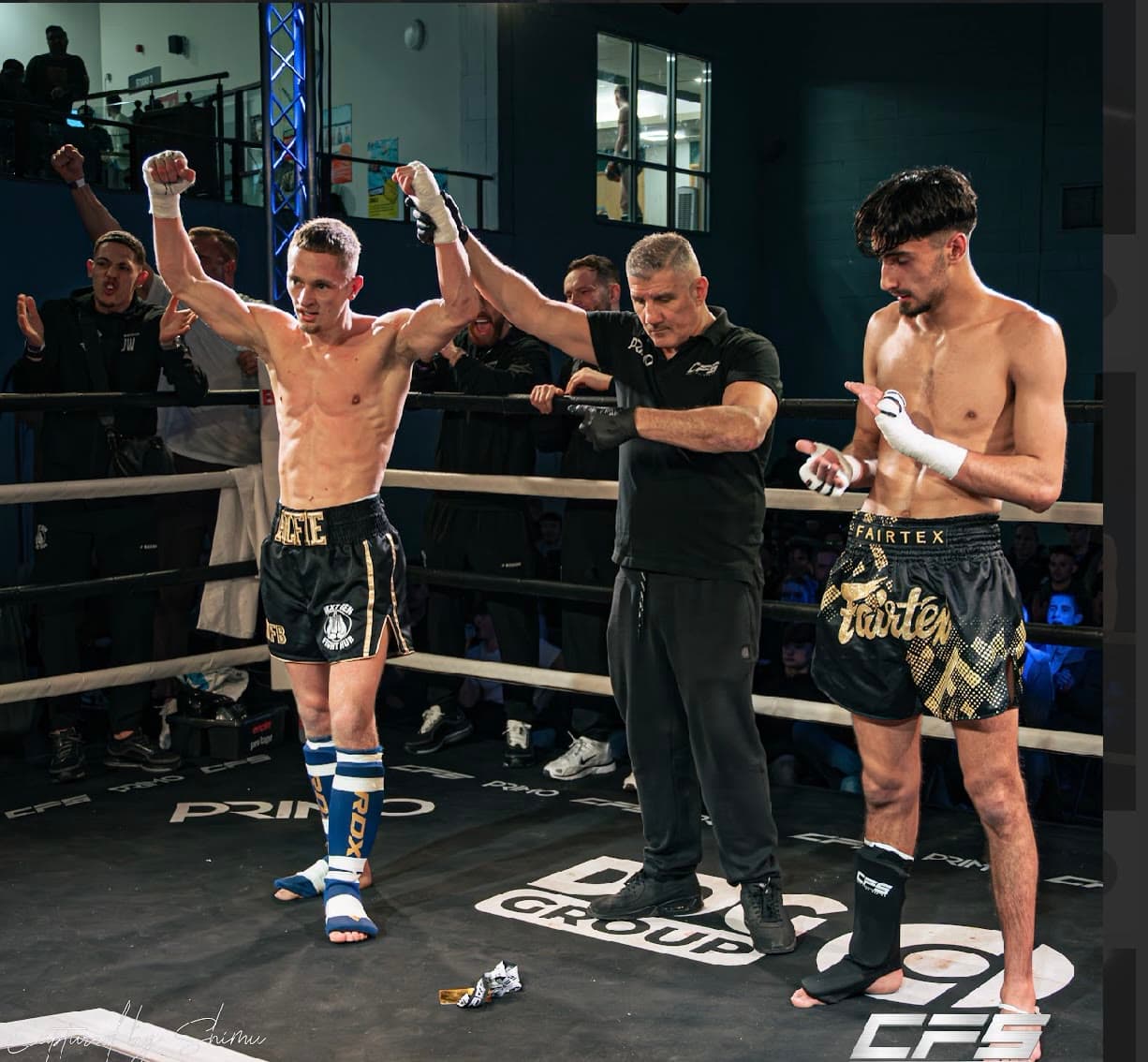 The referee raising a Next Gen fighter's hand after the decision