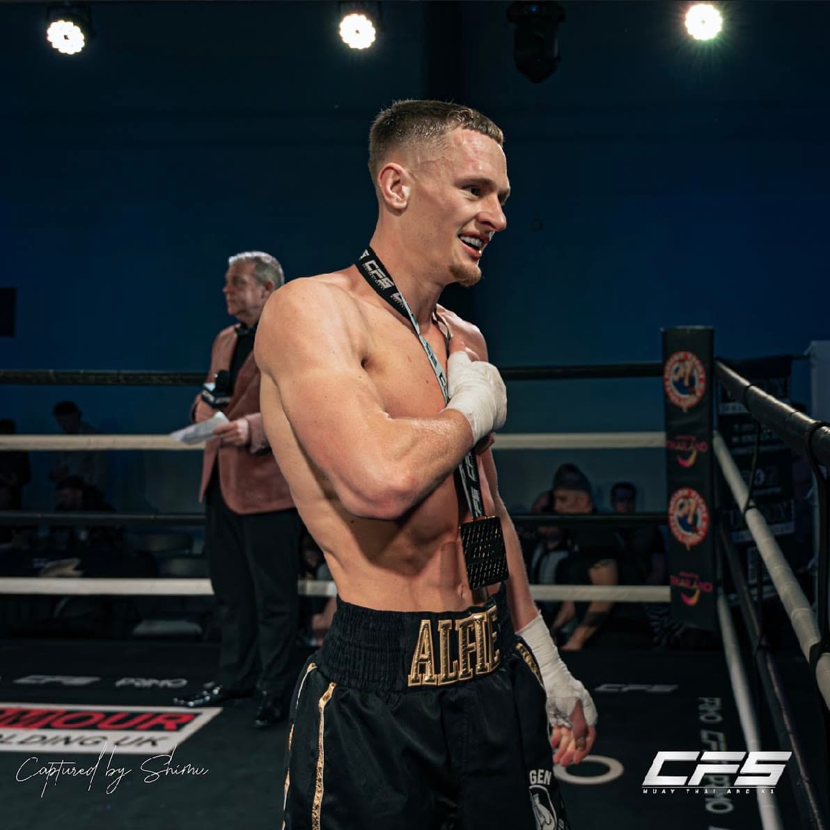 A Next Gen fighter in the ring with his medal after the win