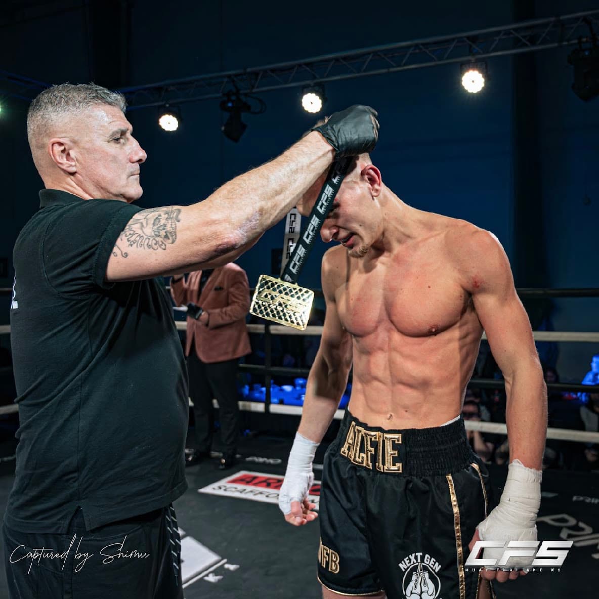A Next Gen fighter being presented with his medal in the ring