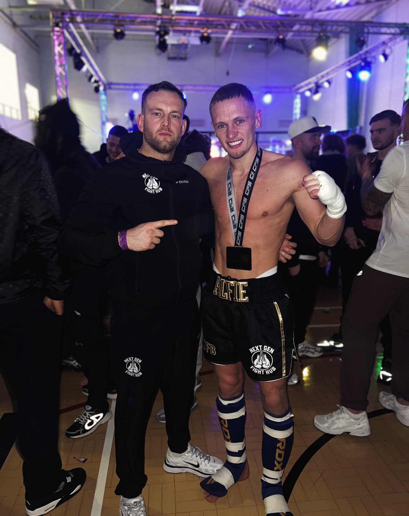 A Next Gen fighter and coach after a win on fight night