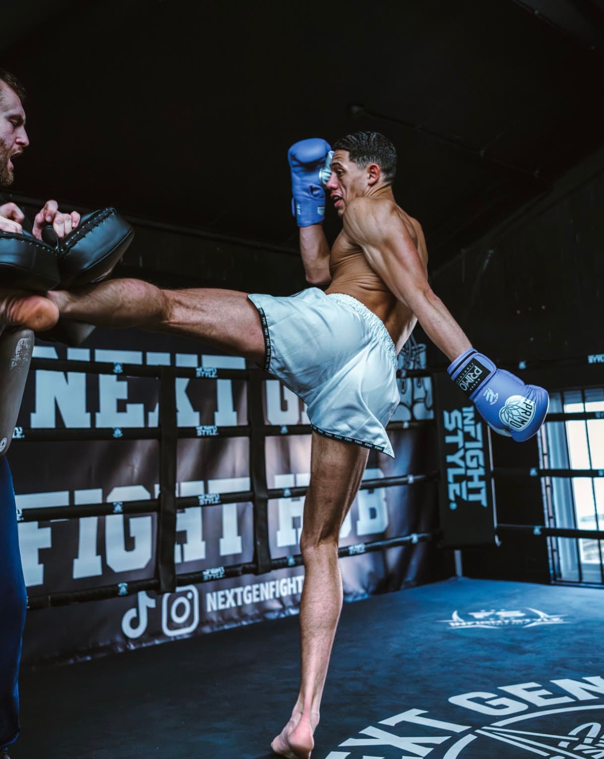 Kicking the pads in the ring at Next Gen Fight Hub