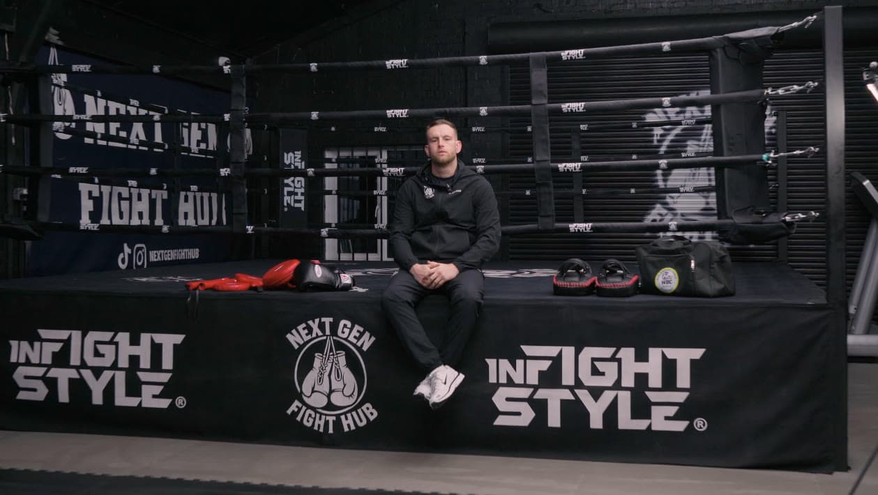 Head coach Hayden sat on the ring apron with the pads beside him