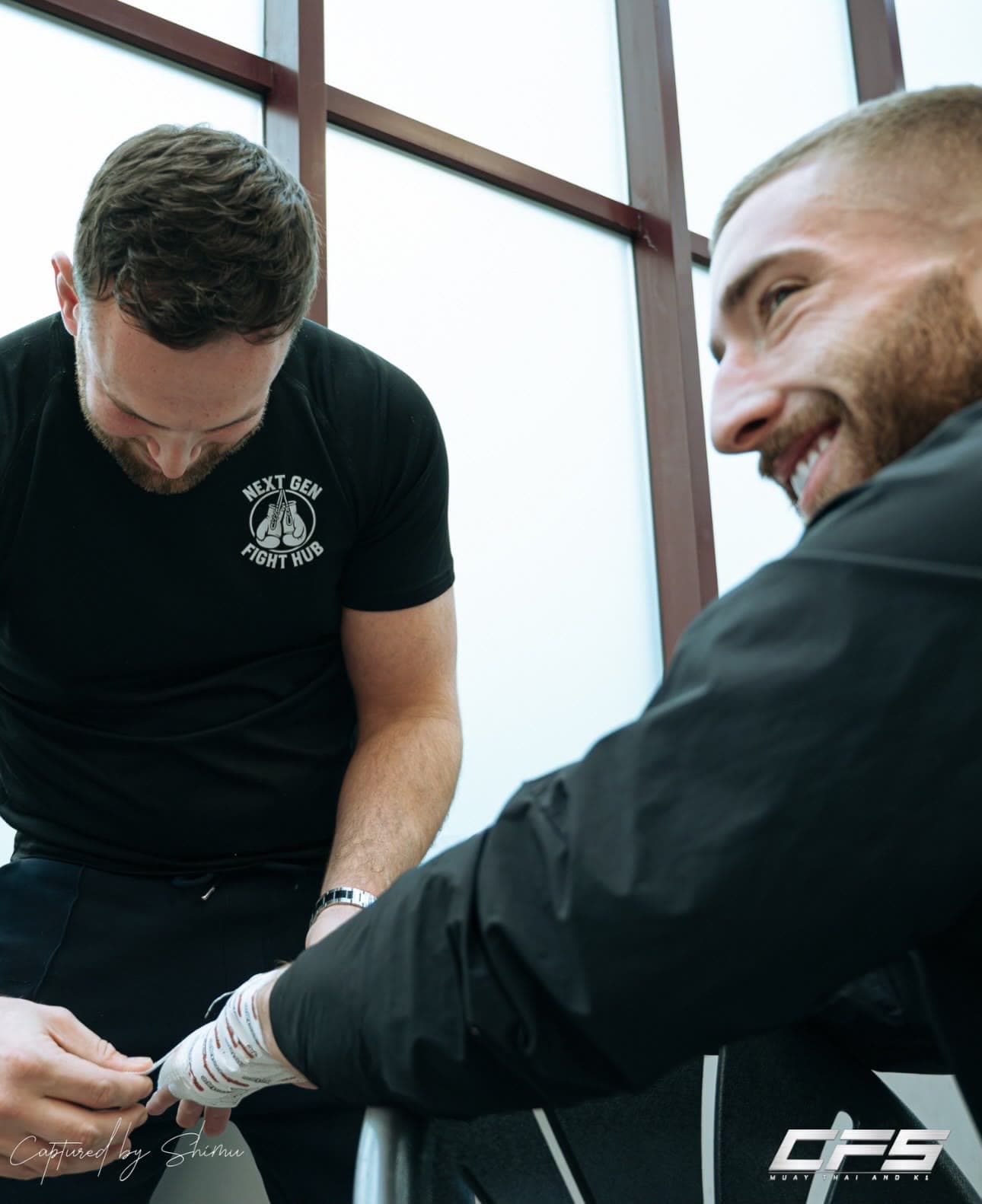 Head coach Hayden wrapping a fighter's hands before a session