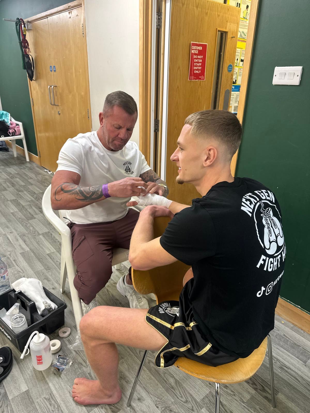 Hands being wrapped backstage before a fight