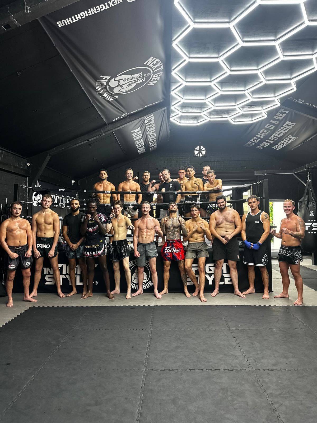 The Next Gen Fight Hub team lined up in front of the ring