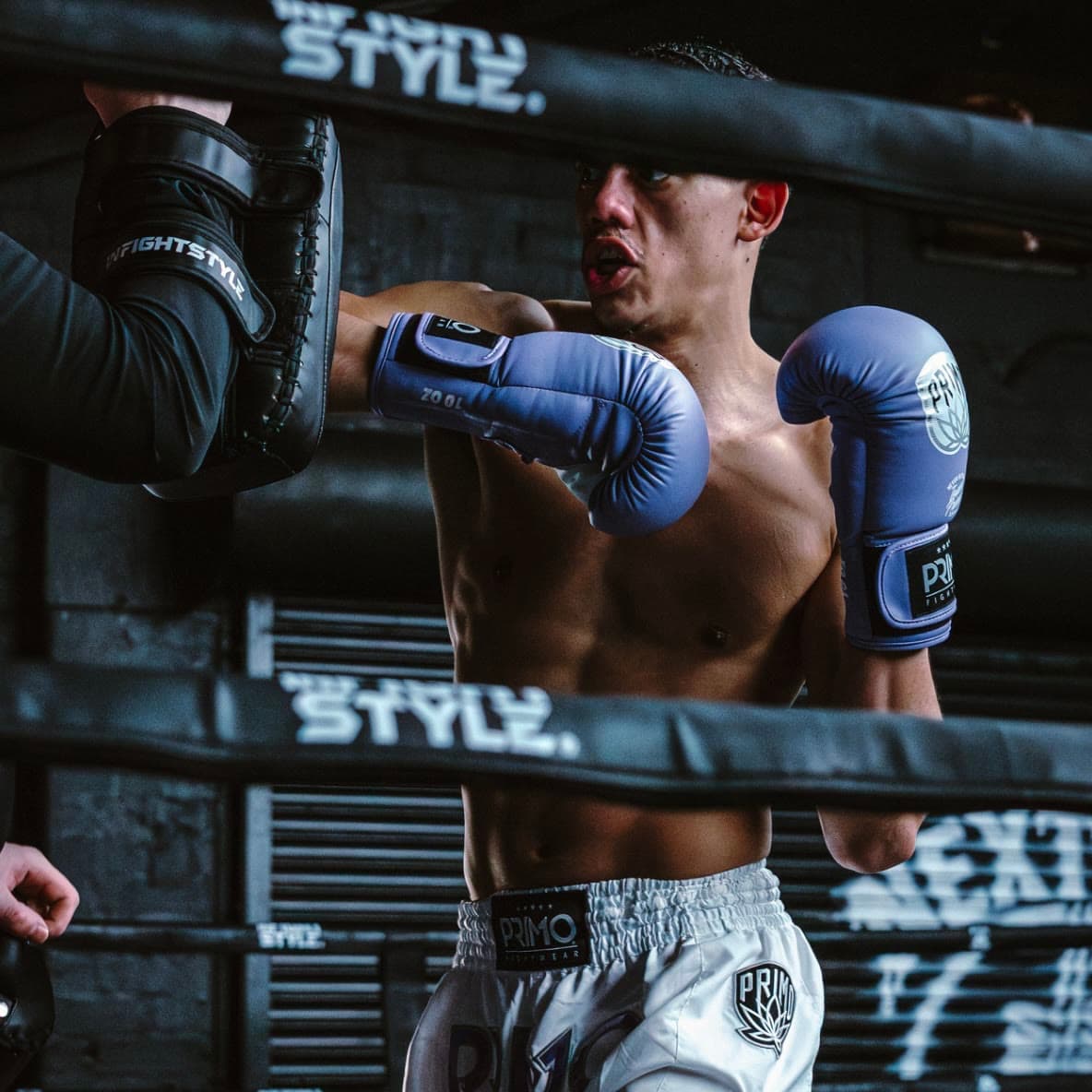Close up of a fighter working combinations on the pads